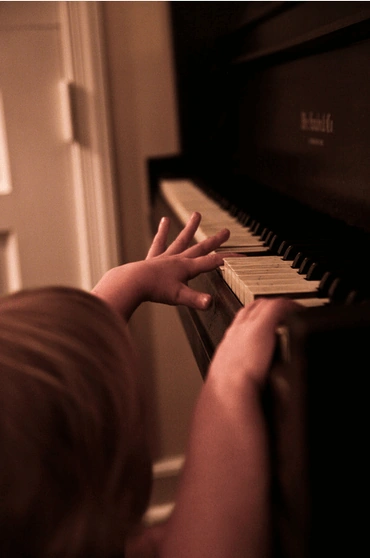 Reaching for the piano.